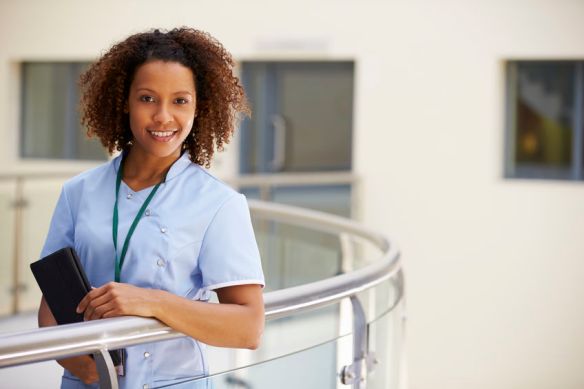 Portrait Of Female Nurse With Digital Tablet In Hospital